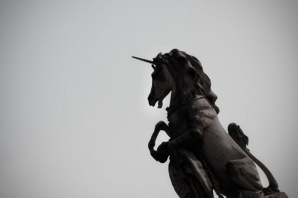 A black and white photo of a unicorn statue 