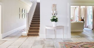 Generously sized hallway painted white to keep it airy and light and no clutter to show how to make a home look expensive
