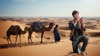 Photo Suggest would probably tell him to turn around and get a shot of those camels