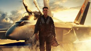 Tom Cruise's Pete Mitchell stands in front of a fighter jet in Top Gun: Maverick