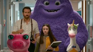 Ryan Reynolds as Cal and Cailey Fleming as Bea walk down a hospital hallway with a large purple furry imaginary friend, an animated unicorn and a pink alligator in the movie IF.