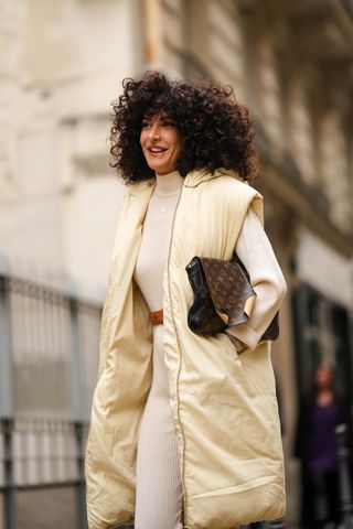 woman wearing puffer vest, turtleneck, and pants