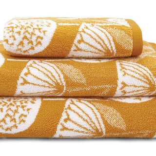 set of towels in yellow colour with white designed