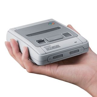 Best retro games consoles; a white handheld game console held in a hand