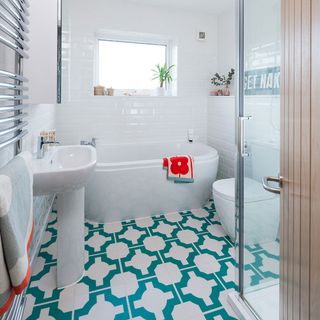 White bathroom with teal patterned vinyl on floor