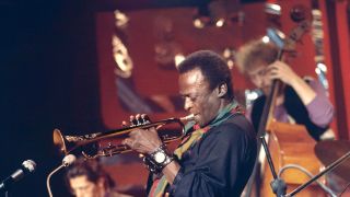American trumpeter and composer Miles Davis (1926 - 1991) performs on stage with pianist Chick Corea and bassist Dave Holland for the BBC 'Jazz Scene' television show filmed at Ronnie Scott's Jazz Club in Soho, London on 2nd November 1969.