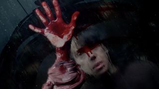 Sally Hawkins with a bloody hand on a window in 2025's horror flick "Bring Her Back." 