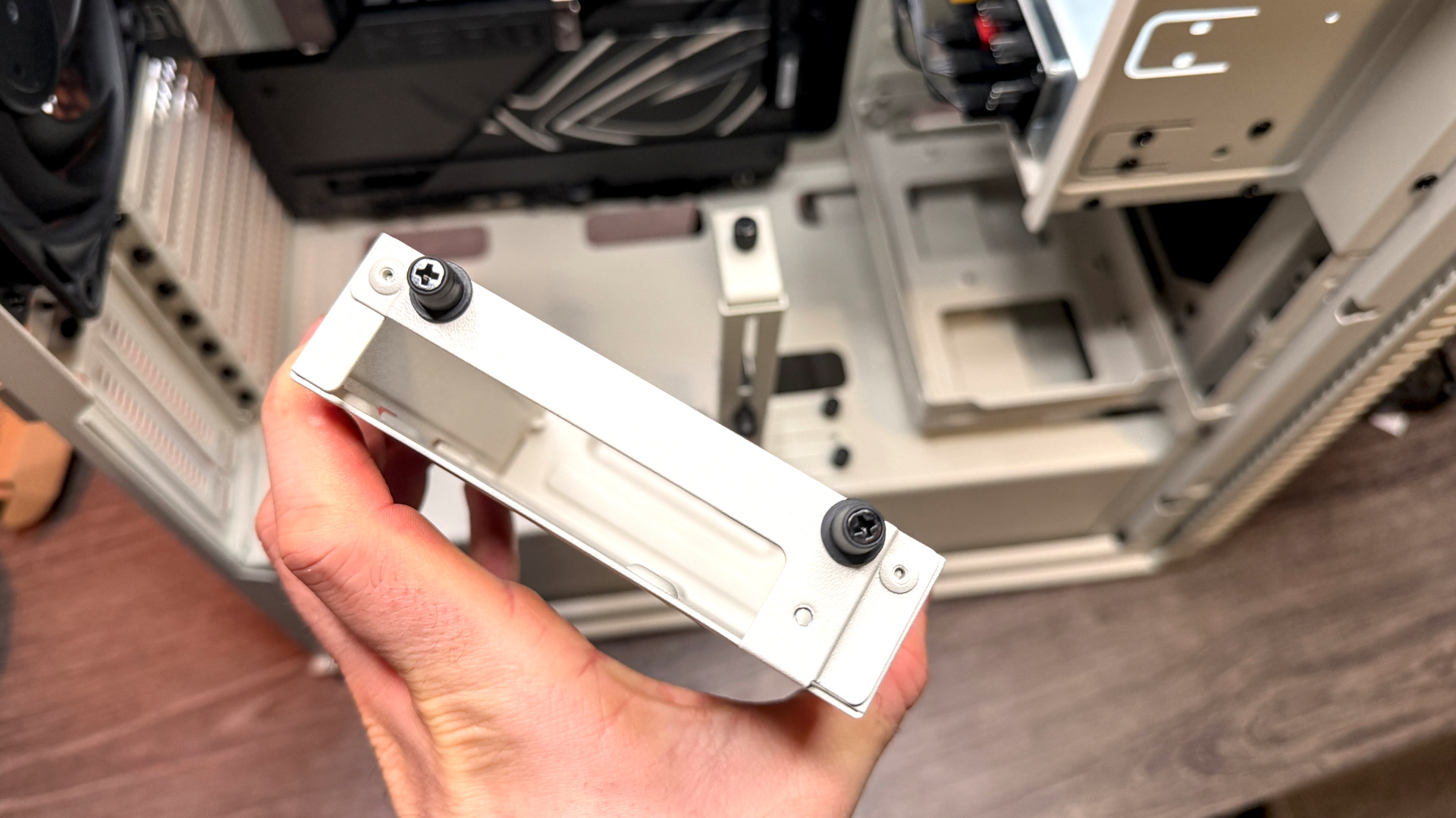 The retro-styled Silverstone FLP02 PC case as a PC is being built into it on a desk.