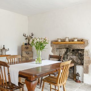 dining room with white walls and wooden dining set