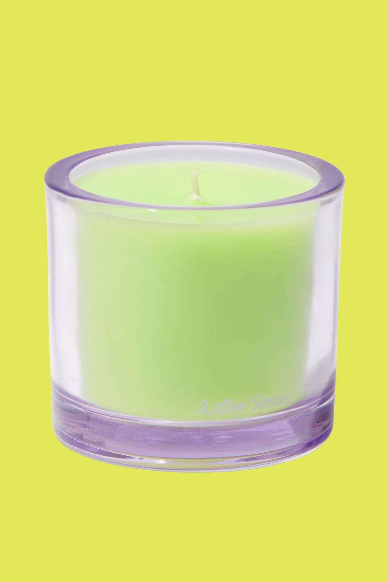 A purple glass candle with green wax