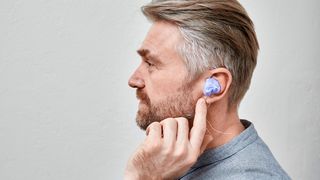 Man having impressions taken of his ears for custom earplugs