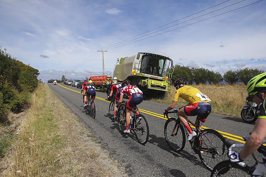 The peloton pass some farm machinery