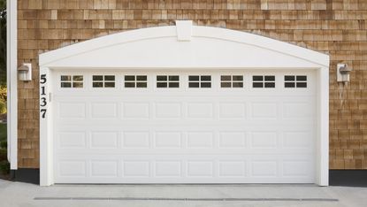 White garage door on a shingled home