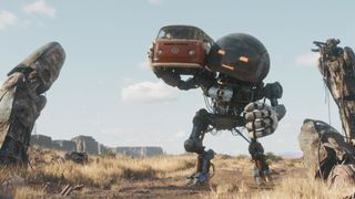 A screenshot from "The Electric State" showing robot Herman (voiced by Anthony Mackie) carrying a VW camper van