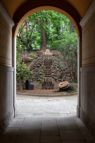 A courtyard with a basket tower.