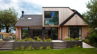 contemporary dormer bungalow with vertical timber cladding