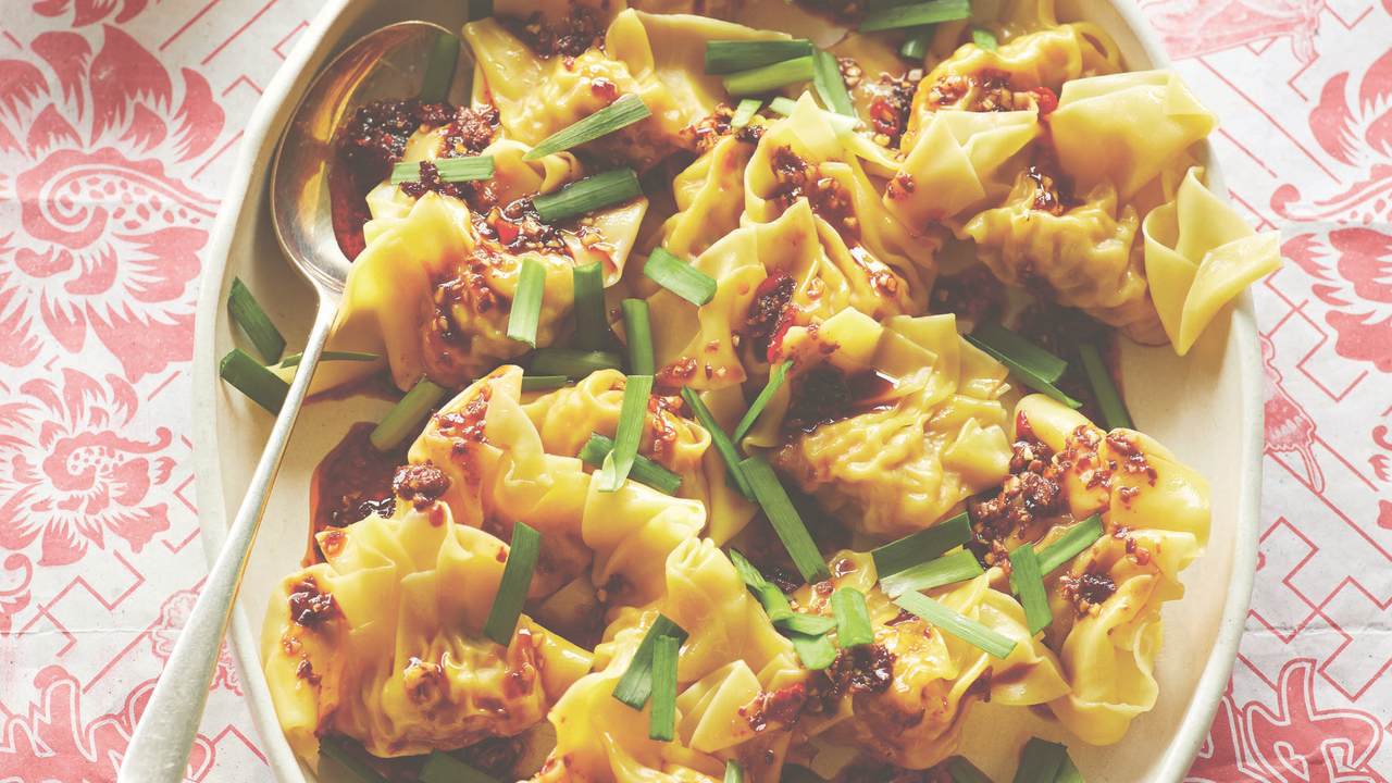 A plate of wontons with chilli dipping sauce