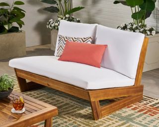 Christopher Knight Home Sherwood Outdoor Acacia Wood Loveseat in white on patio ontop of rug with plants surrounding it
