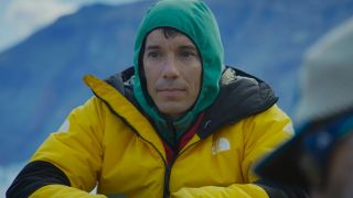 Alex Honnold sitting with a hood on in Arctic Ascent. 