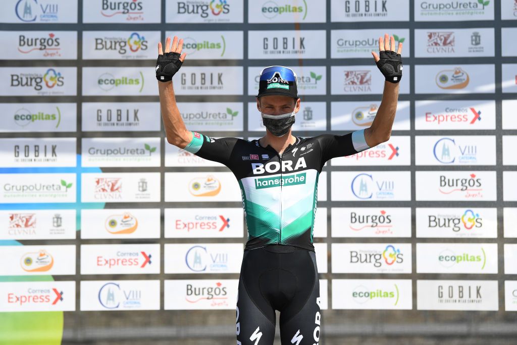 Felix Gro&szlig;schartner wears a face mask on the podium after winning stage 1 of theVuelta a Burgos