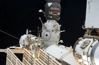 Cosmonauts Retrieve and Replace Science Experiments During Spacewalk