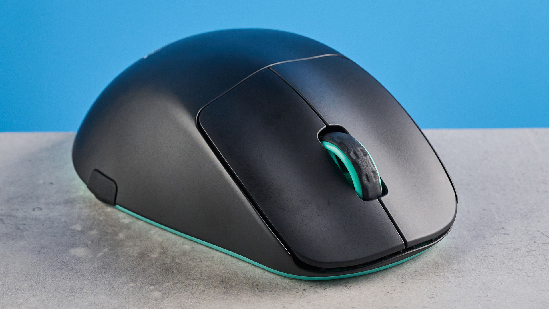A black and teal Cherry XTRFY M64 Wireless gaming mouse