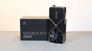 An Nvidia RTX 4090 standing upright next to its retail packaging
