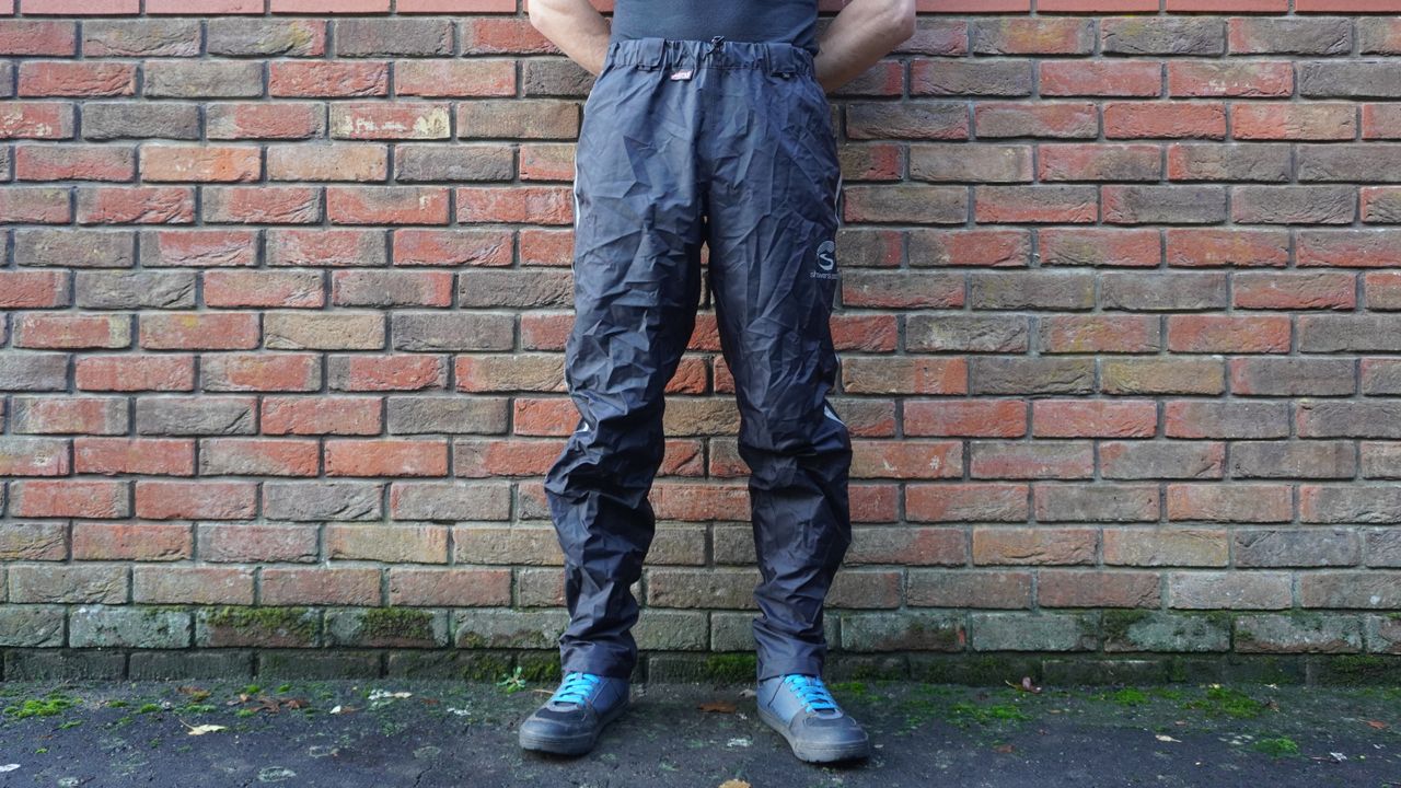 Image shows a rider wearing the Showers Pass Transit Pants.