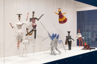 Puppets and tin man sculptures in gallery