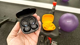 The Anker Soundcore Sport X20 hovering over the Beats Powerbeats Pro 2