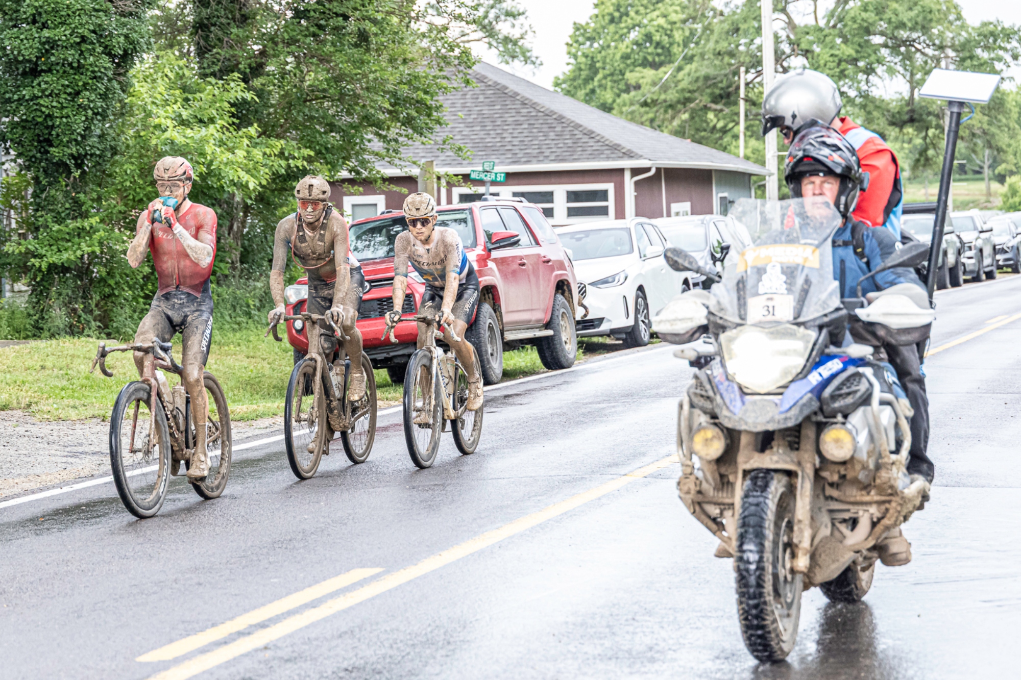A motorcycle carying a camera man follows the racers