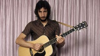 Pete TOWNSHEND and The Who, Pete Townshend, posed, playing Martin acoustic guitar 