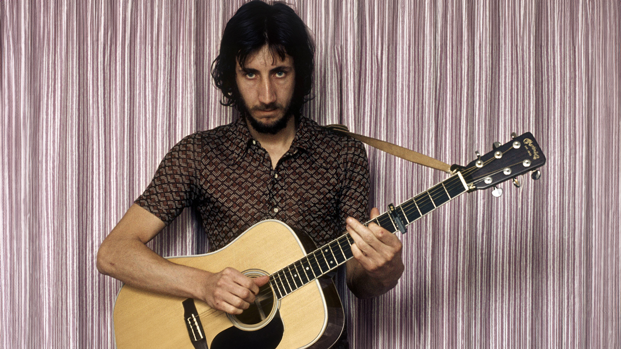 Pete TOWNSHEND and The Who, Pete Townshend, posed, playing Martin acoustic guitar 