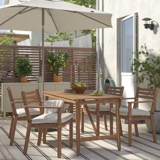 IKEA ASKHOLMEN dining table and chairs set outdoors in a garden in the sun
