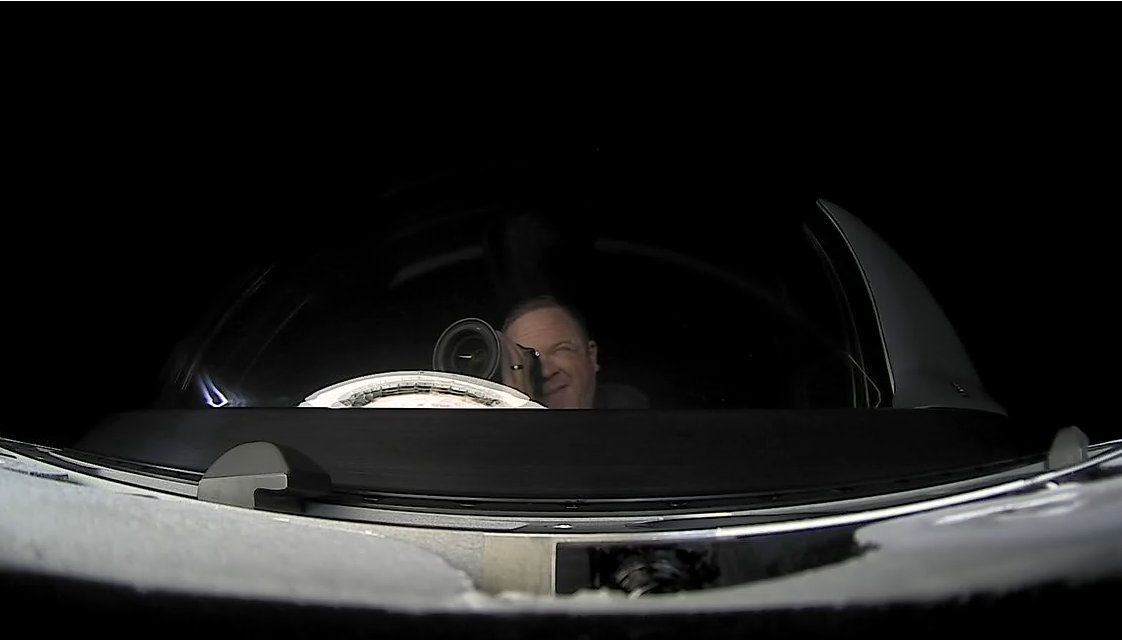 Chris Sembroski, Inspiration4 mission specialist, is seen taking photographs in SpaceX's Crew Dragon cupola during the mission.