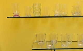 Close up of glassware on yellow shelves