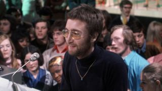 John Lennon (1940-1980) becomes the first of The Beatles, post-breakup, to play on Top of the Pops where he performed his single "Instant Karma!" on February 11, 1970, in Studio Eight at BBC Television Centre, in London, England. (Photo by Icon and Image/Getty Images)