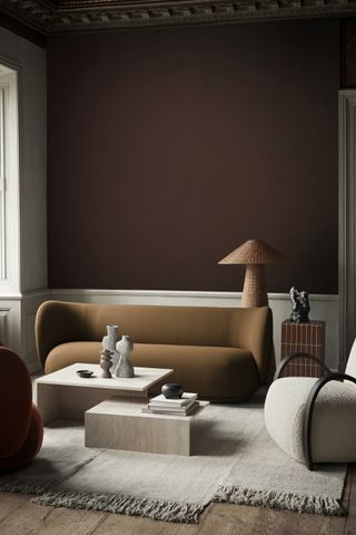 Living room with brown wall and caramel furnishings