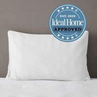 White memory foam pillow standing against grey wall, Ideal Home Approved