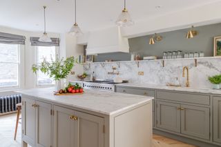 grey and white kitchen with gold accent lighting