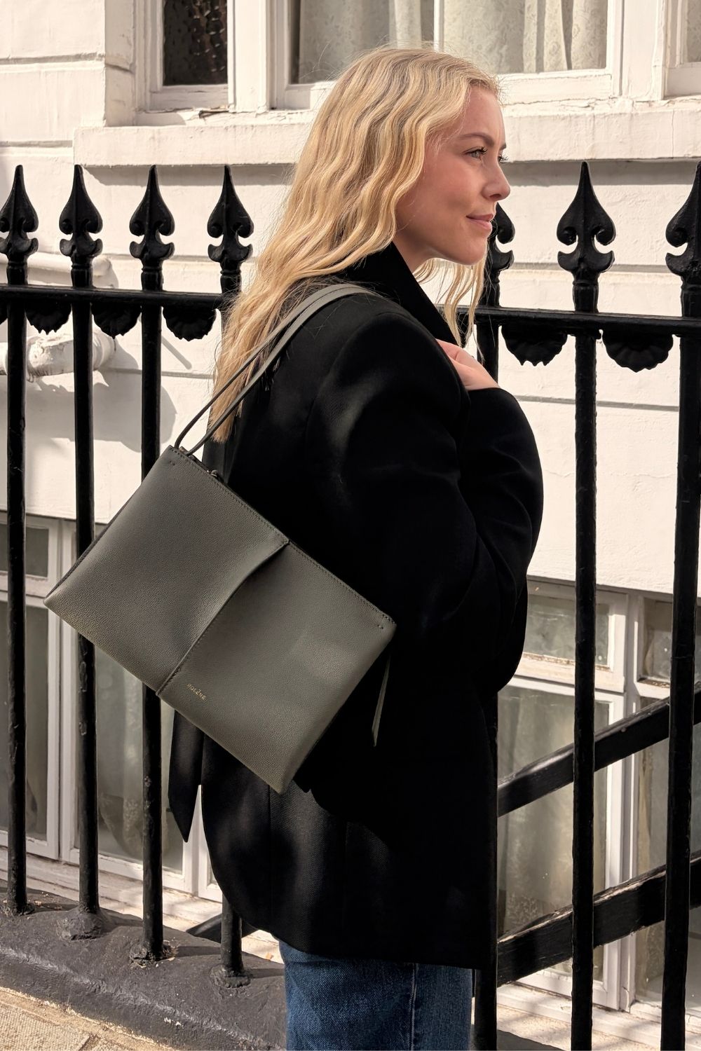 Shopping editor, Florrie, carries the Pol&amp;egrave;ne Boky bag, wears a black blazer and blue jeans