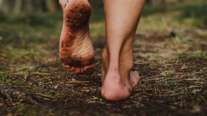 Person walking barefoot on the ground