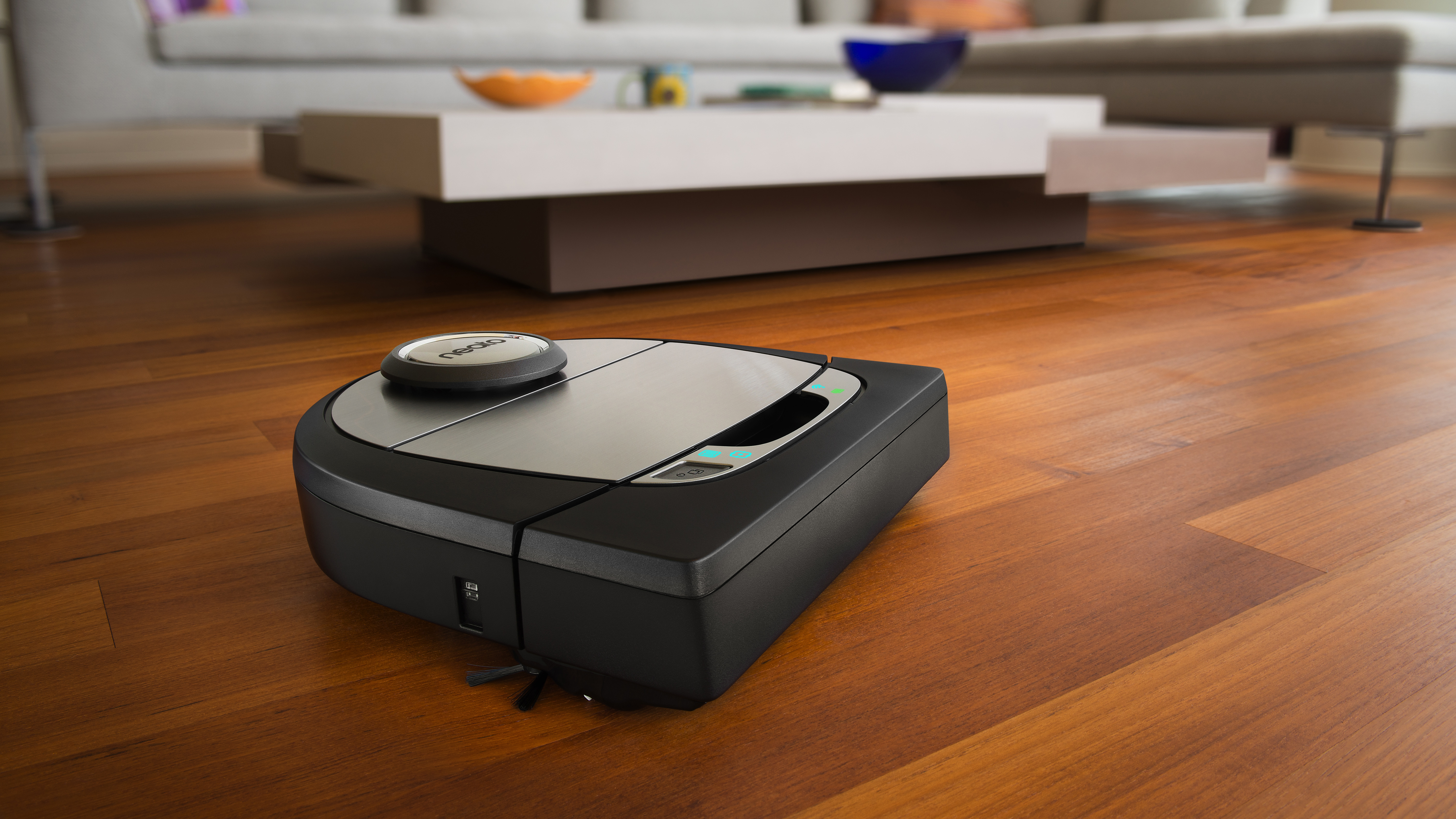 The Neato Botvac D7 robot vacuum on a wooden living room floor