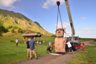 placing rapa nui statue in place for moai walking demonstration