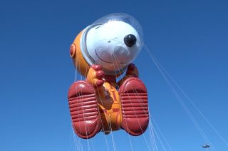 The Macy's Thanksgiving Day Parade Astronaut Snoopy balloon, seen here during a test flight in 2019, was modeled after NASA's Orion Crew Survival System that Artemis crews will wear to the moon.