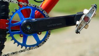 e*thirteen Helix Race crankset pictured side on fitted to an orange bike