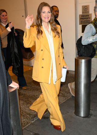 Drew Barrymore in a yellow trouser suit