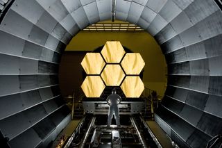 NASA engineer Ernie Wright looks on as the first six flight-ready James Webb Space Telescope's primary mirror segments are prepped for final cryogenic testing at NASA's Marshall Space Flight Center.