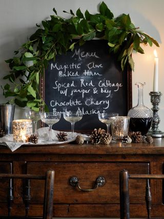 foliage garland around a chalk board menu