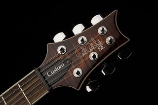 A photo of the headstock of the PRS SE Custom 24 Semi-Hollow Piezo